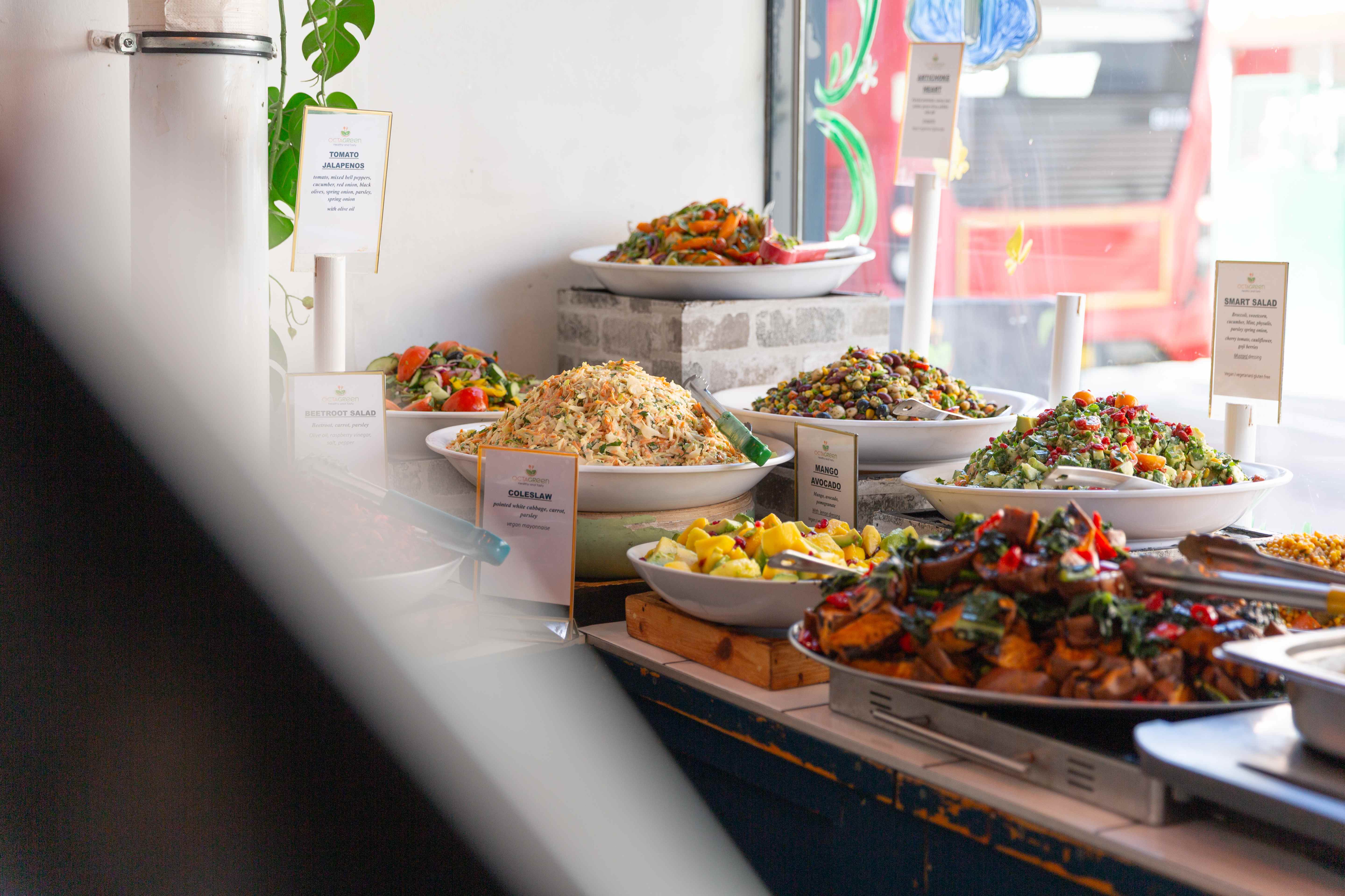 Fresh salad bar display with colorful bowls