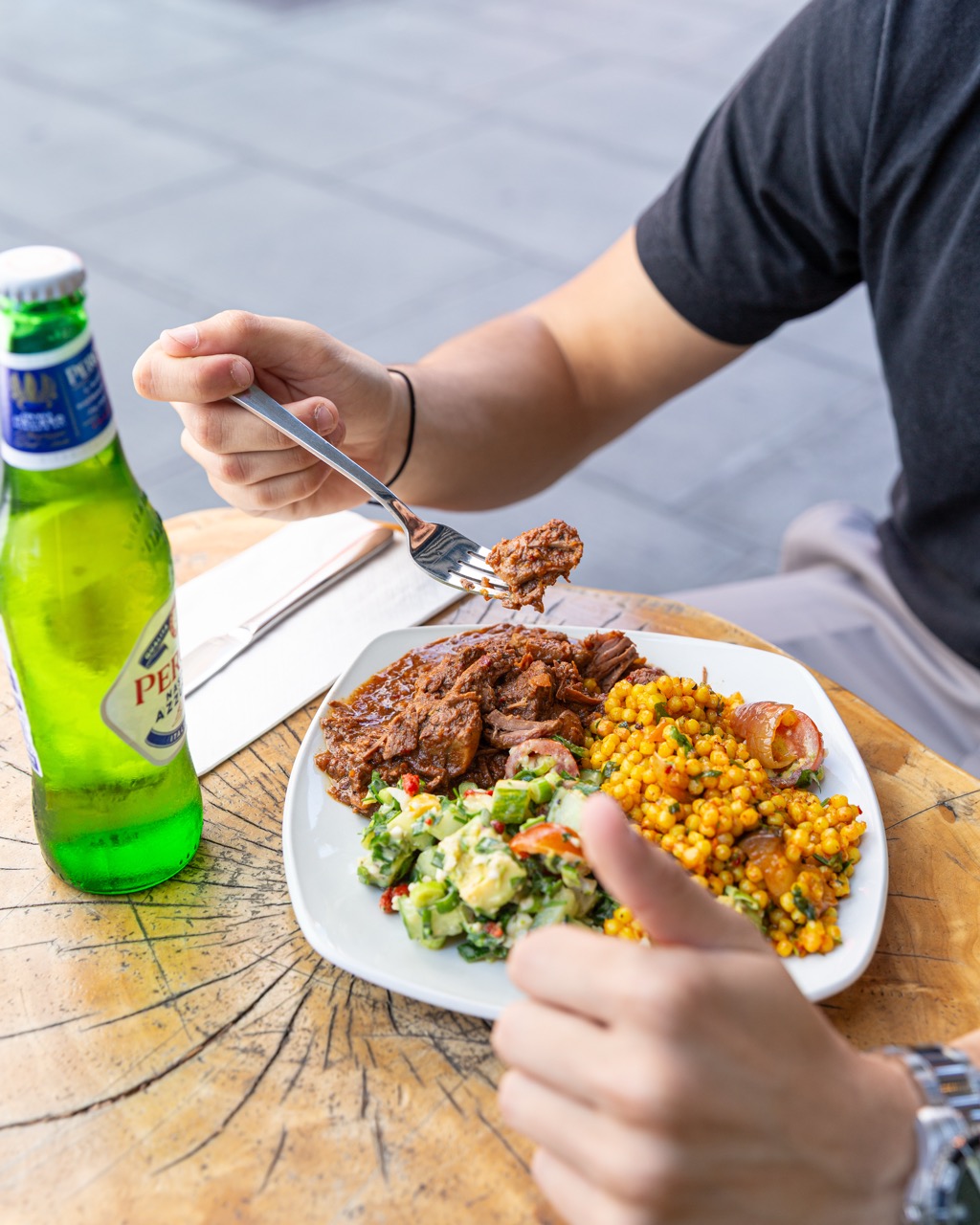 Outdoor dining experience with hearty meal and beer